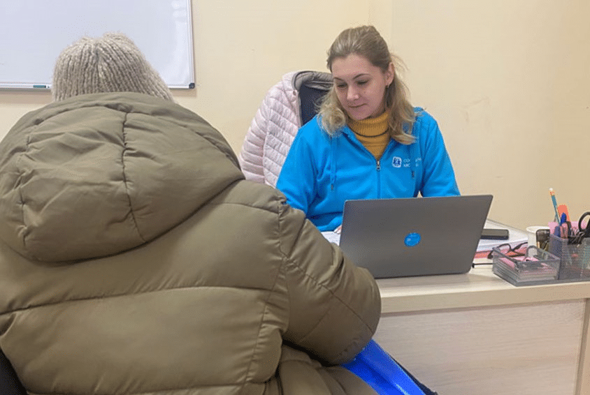 Fra et sosialsenter i Lviv der en kvinne snakker med en medarbeider fra SOS-barnebyer. Foto: Sigurd Skjefstad