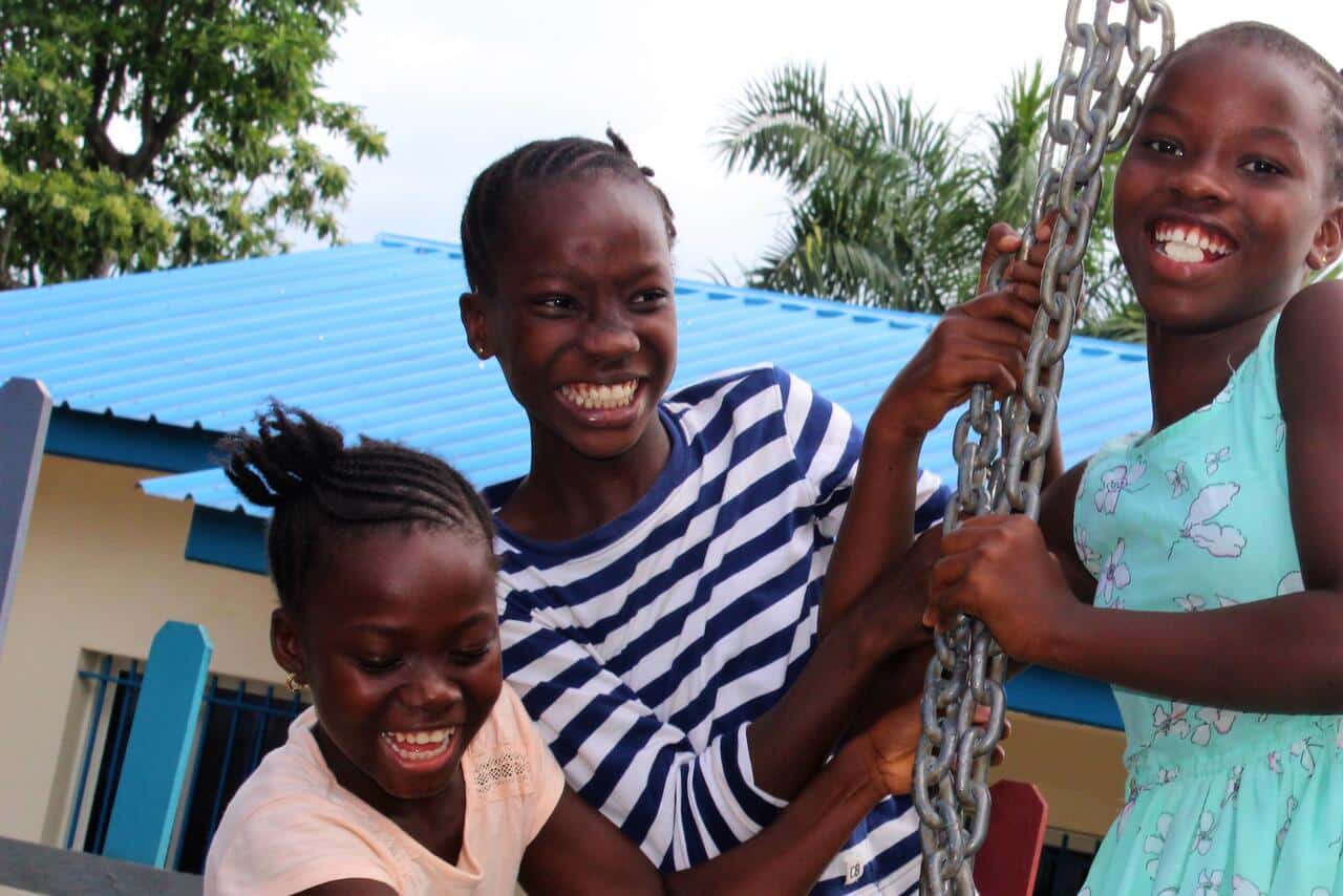 Tree barn Malawi leker og smiler ute i lekeplassen.